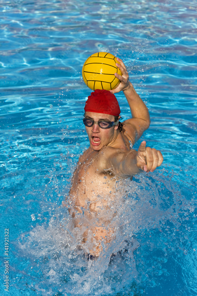 Water Polo player shouts and gets ready to pass ball.