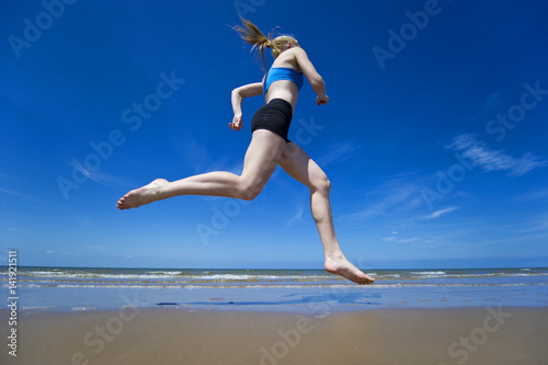 Fototapeta Naklejka Na Ścianę i Meble -  Female Athlete running on Beach