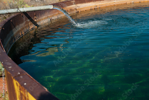 Pipe Filling Large Tank with Water, Sedona, Arizona, USA, horizontal