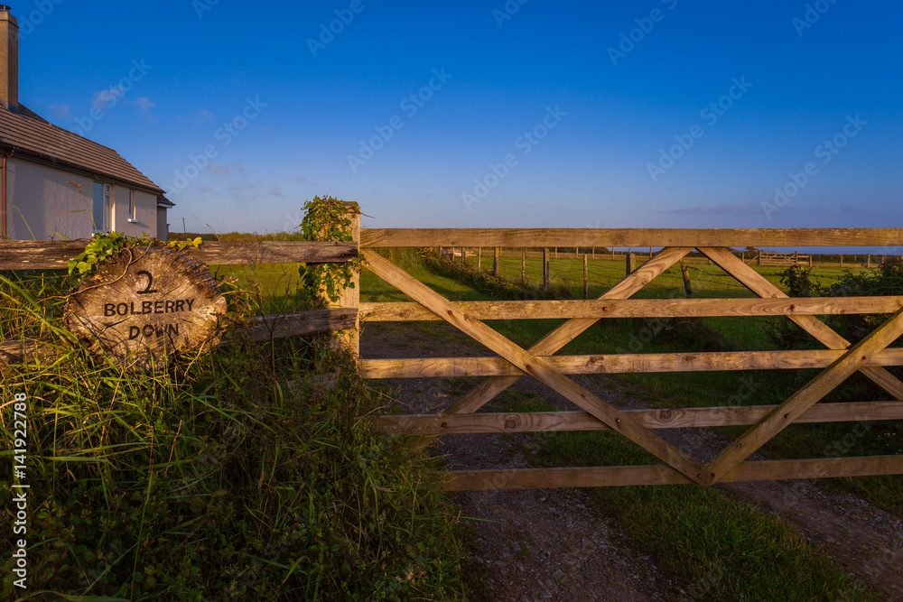 The Gates Of The Farmhouse Are Lit By The Rays Of The Setting Sun ...