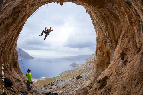 Rock climbers in cave photo
