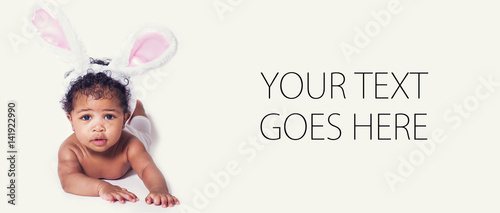 Cute baby girl portrait wearing bunny ears, card