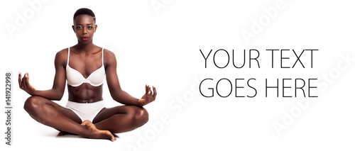 Gorgeous african girl portrait sitting cross-legged while meditating, card