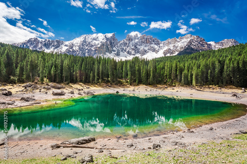 Green mountain Carezza lake in spring, Alps, Italy, Europe