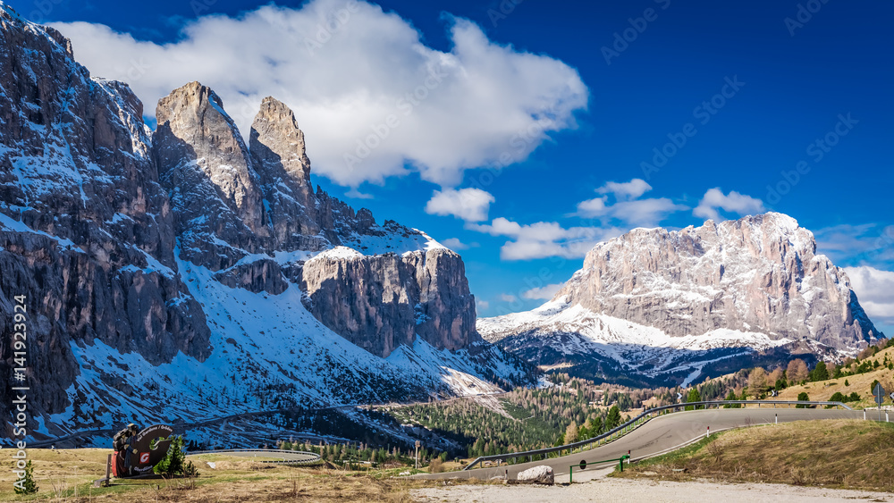 Road leading to snow capped Dolomites, Italy, Europe