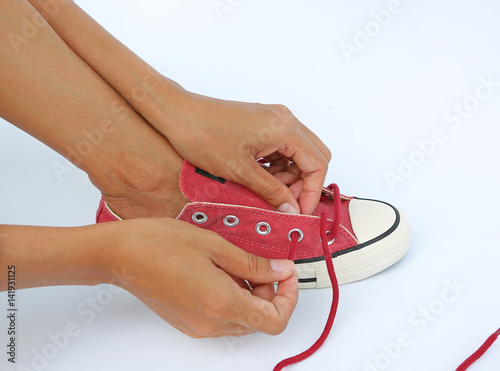 Tie her shoes canvas Sneakers on white background photo