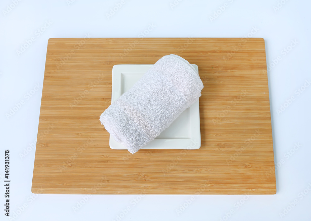 Fototapeta premium Spa concept, Towels on bamboo board against white background