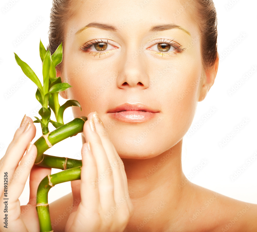 young woman with a bamboo plant young woman with a bamboo plant