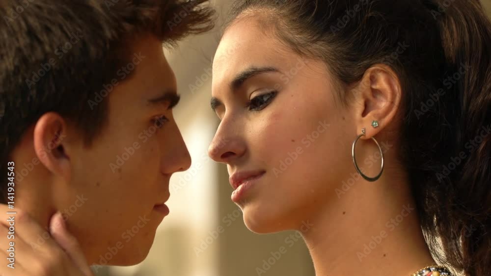 Beautiful Young Couple in Love embrace and kiss Beautiful Young Couple in Love embrace and kiss