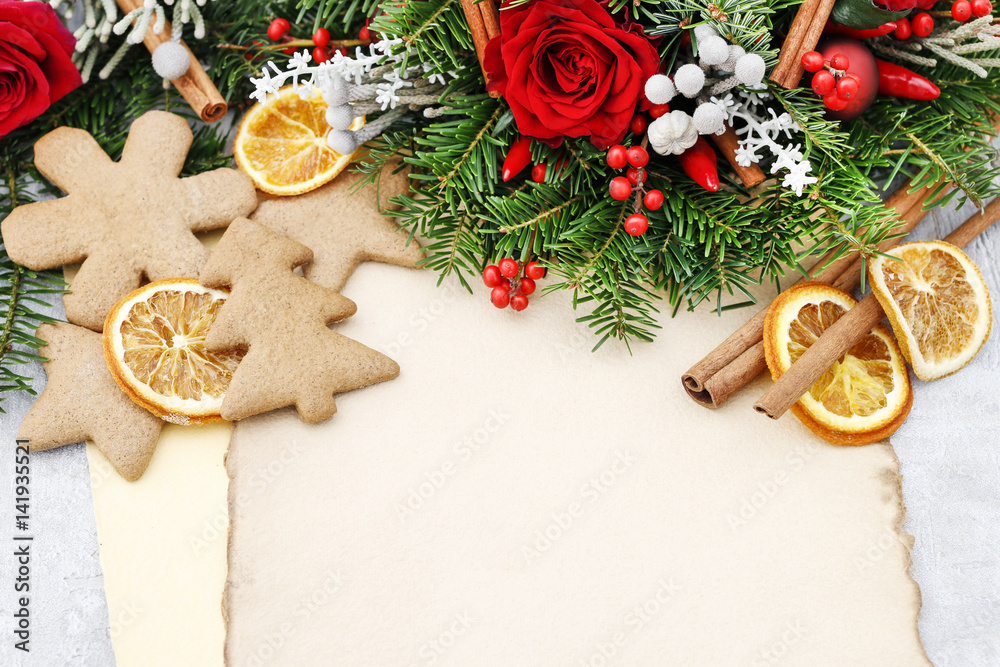 Christmas background with gingerbread cookies, fir wreath, dried fruits and vintage sheets of paper. Christmas background with gingerbread cookies, fir wreath, dried fruits and vintage sheets of paper.