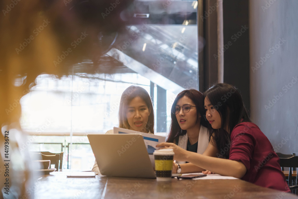 3 teenagers friends meet in coffee shop, using technology device  together