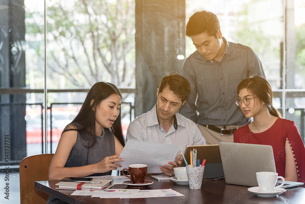 4 people meeting in coffee shop, business casual conceptual