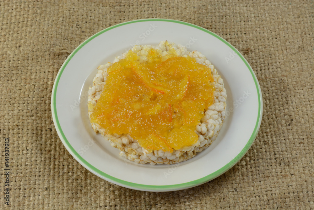 Orange marmalade in brown rice cake in plate Orange marmalade in brown rice cake in plate