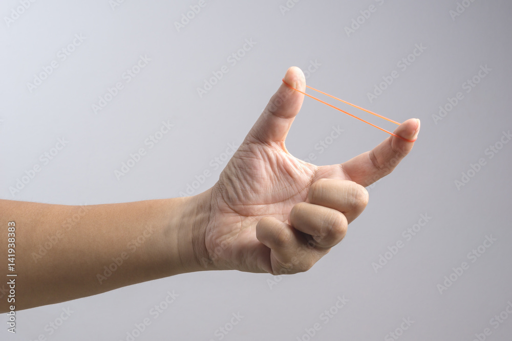 Hand holding elastic rubber band Hand holding elastic rubber band