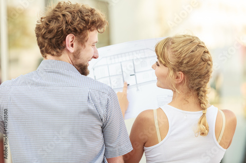 couple with blueprint project  building plans outdoor © anetlanda