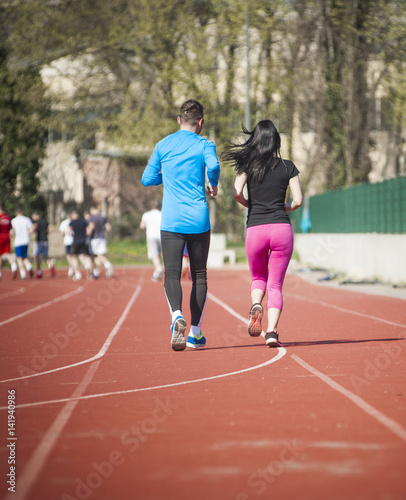 Young couple exercise running on the track © kroko021