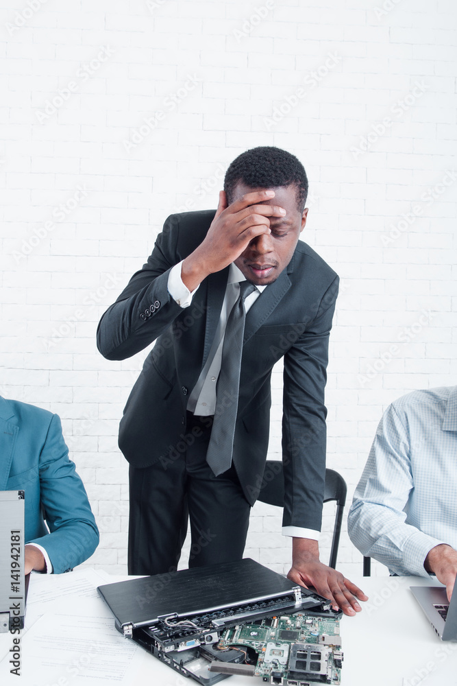 Bankruptcy of company. Disappointed and stressed leading manager with broken laptop. Stress, fail, problem at work concept Bankruptcy of company. Disappointed and stressed leading manager with broken laptop. Stress, fail, problem at work concept