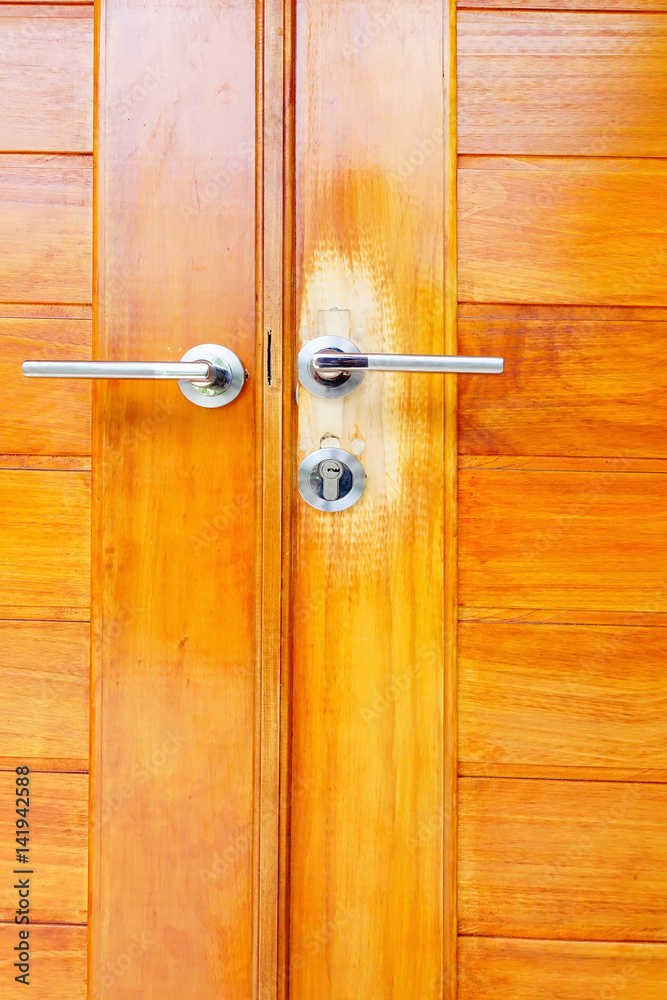 Close up brown modern wooden door with handle Close up brown modern wooden door with handle