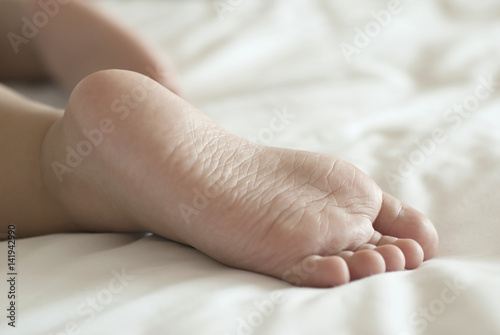 Close up of baby feet in a bed