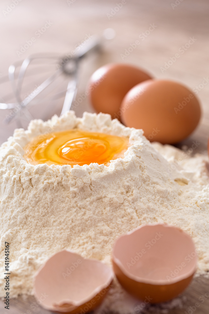 Mixing egg and flour . Mixing egg and flour .