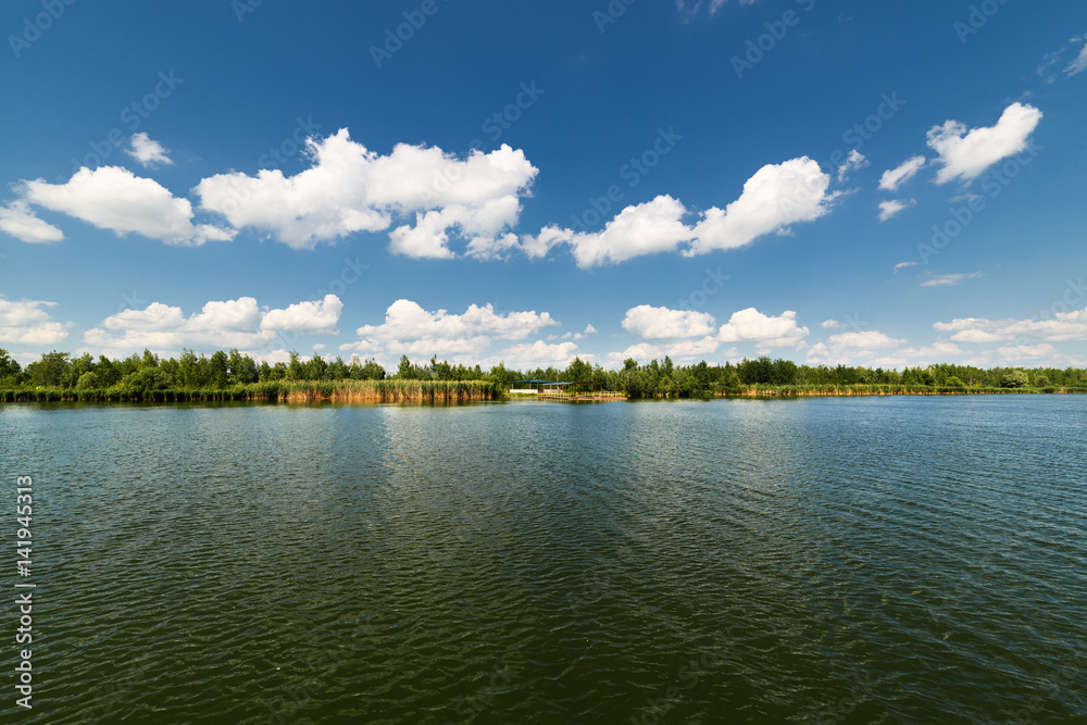 Clean lake and beautiful blue sky with clouds