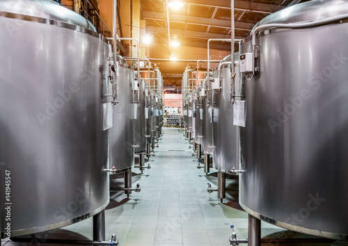 Rows of steel tanks for beer fermentation and maturation. photo