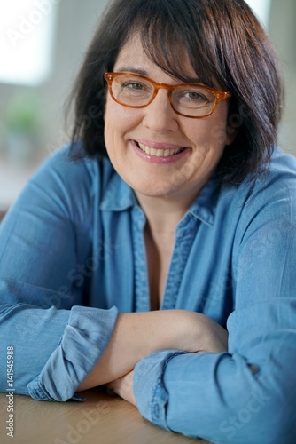 Portrait of cheerful mature woman with eyeglasses