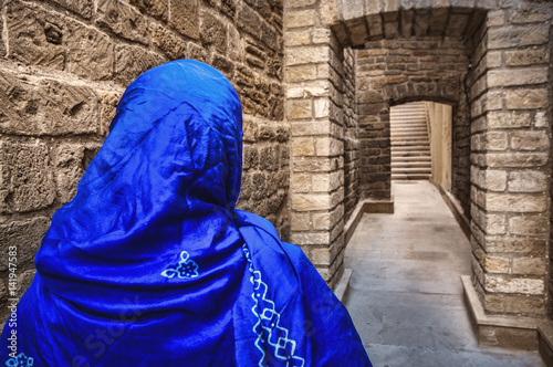 Muslim traditional woman visiting old historical city in Baku Azerbaijan. Innrer city photo