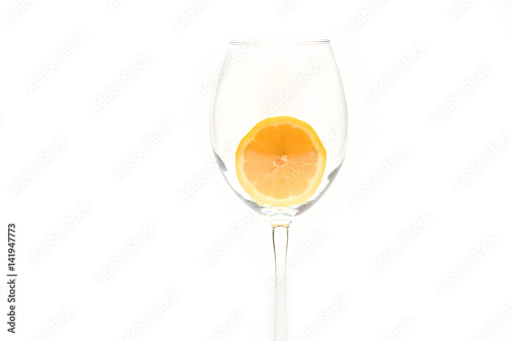 Slice of lemon in glass isolated on white background Slice of lemon in glass isolated on white background