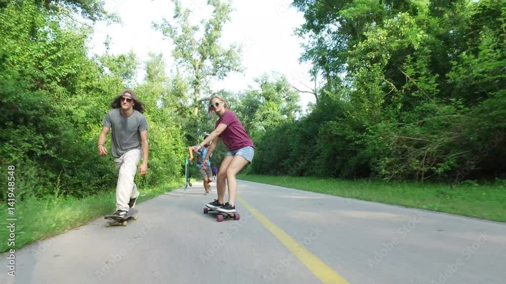 Front view of three cool cheerful friends skateboarding Front view of three cool cheerful friends skateboarding