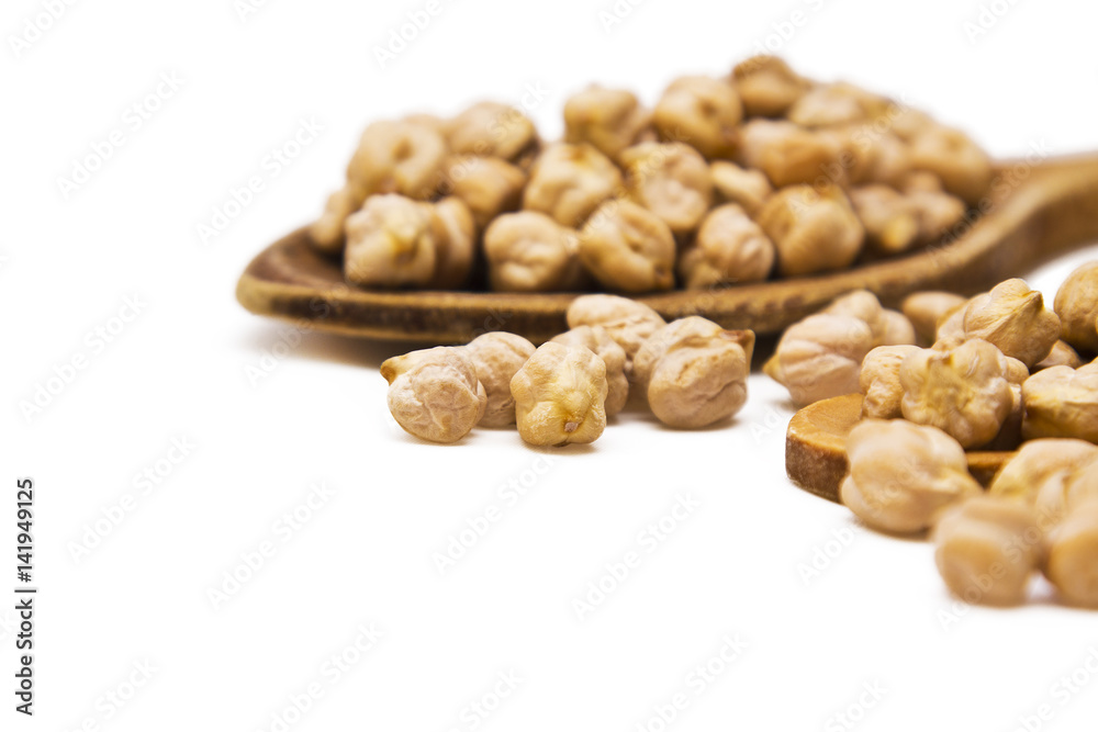 Lots of chickpeas in the wooden spoon isolated Lots of chickpeas in the wooden spoon isolated