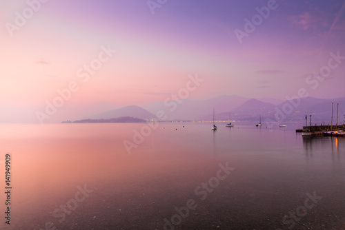 Fototapeta Naklejka Na Ścianę i Meble -  Lake Maggiore, Laveno, Cerro, Italy. Picturesque and romantic sunset on Lake Maggiore from the lakeside of the small village of Cerro. In the background the Piedmont side, between Pallanza and Intra