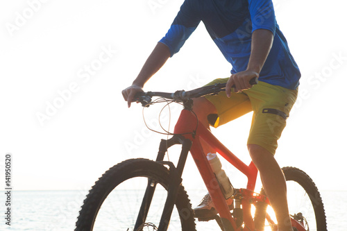 Man riding a mountain bike on the beach