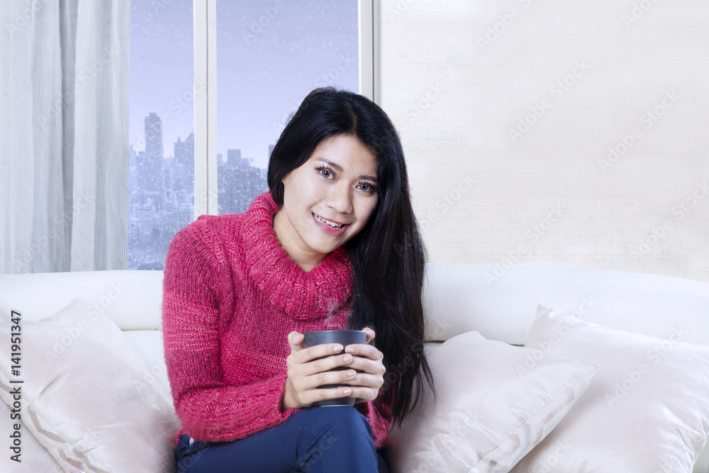 Asian woman relaxing with a cup of tea