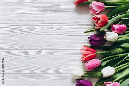 Fototapeta Naklejka Na Ścianę i Meble -  Fresh tulips on a wooden background for Mother's Day.