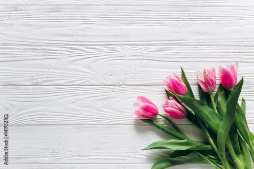 Fototapeta Naklejka Na Ścianę i Meble -  Fresh tulips on a white wooden background for Mother's Day.