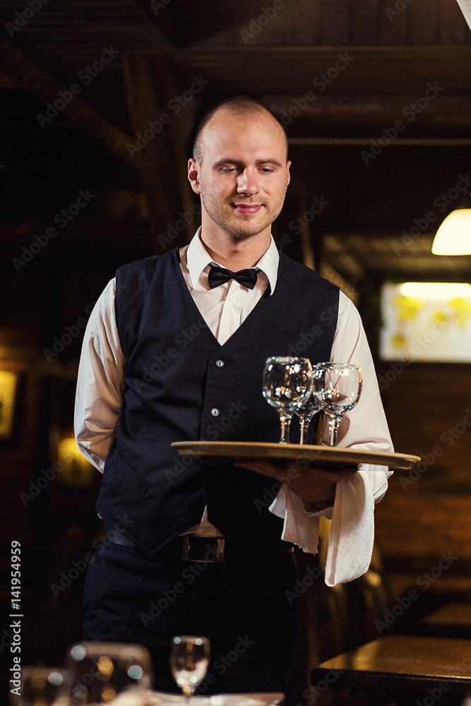 Waiter served table in the restaurant before the feast,Waiter in
