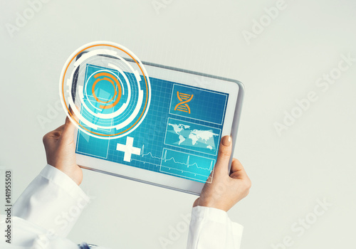 Close of female doctor hands working with tablet pc computer