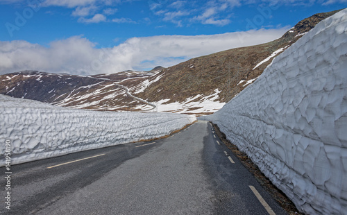 Snow wall on the road Tindevegen - the highland road in Norway. photo