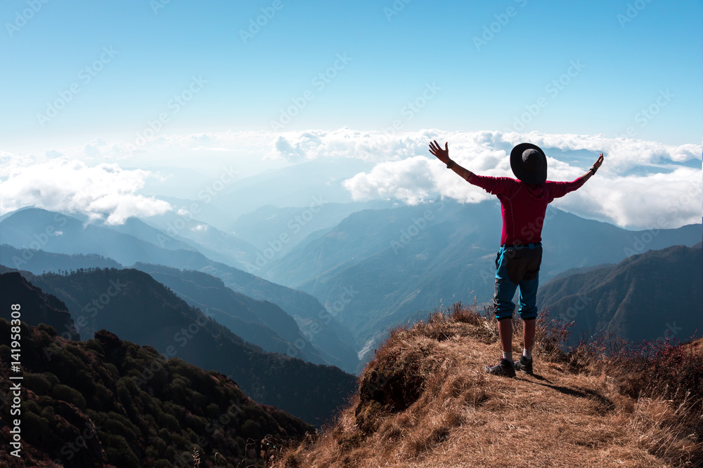 Ecstatic Person in Mountains embracing the World Gesture