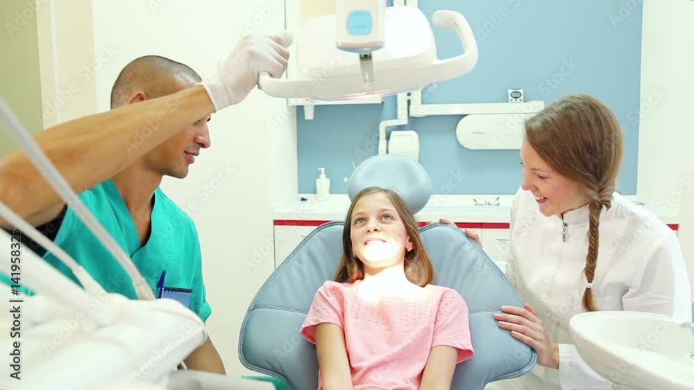 male dental surgeon exams cute little patient with toothache male dental surgeon exams cute little patient with toothache