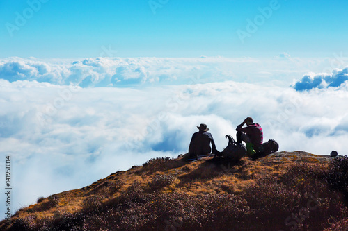 People relaxing on Mountain Cliff enjoying cloud Sky Horizon