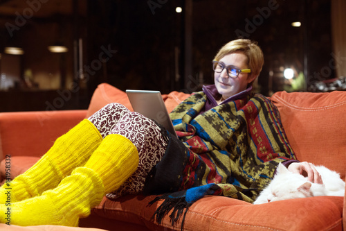 Cozy Home Interior and Woman reading Tablet playing with Cat