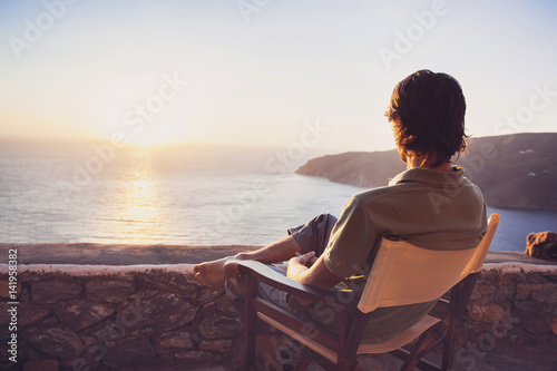 Enjoying life. Young man looking at the sea, vacations lifestyle concept