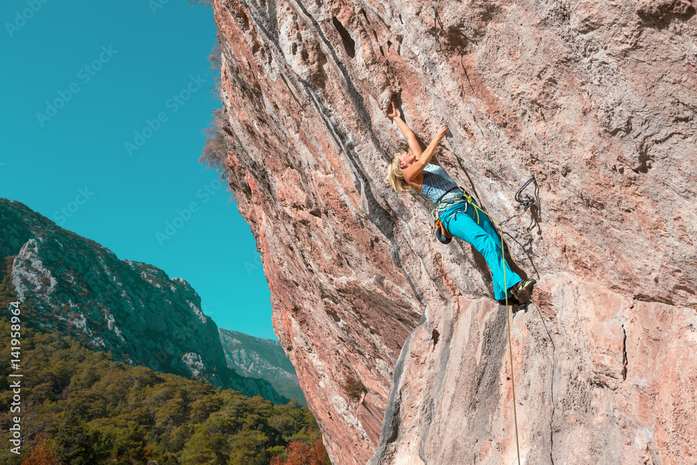 Female Rock Climber on high Wall Female Rock Climber on high Wall