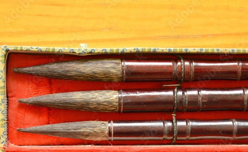 Chinese calligraphy variety size in box on wooden table