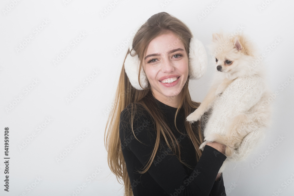 sexy pretty happy girl with small pomeranian dog in earmuffs sexy pretty happy girl with small pomeranian dog in earmuffs