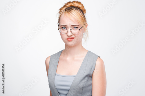 Foto Young blonde in glasses shows contempt and neglect
