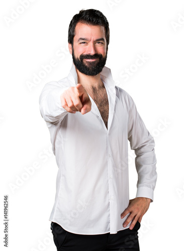 Handsome man with beard pointing to the front