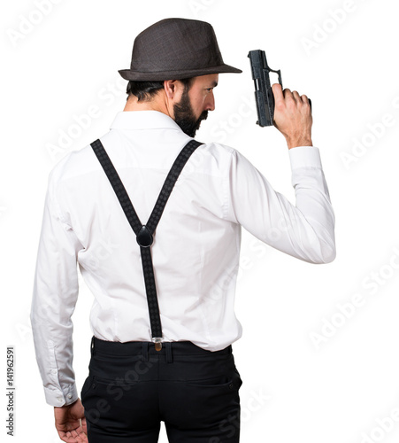 Hipster man with beard with a pistol